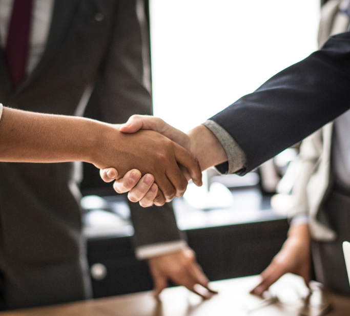 business-people-shaking-hands-meeting-room